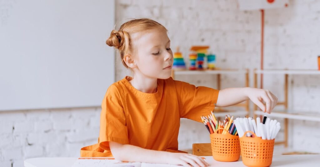 A girl in a bright classroom selects coloring tools for an educational activity.
