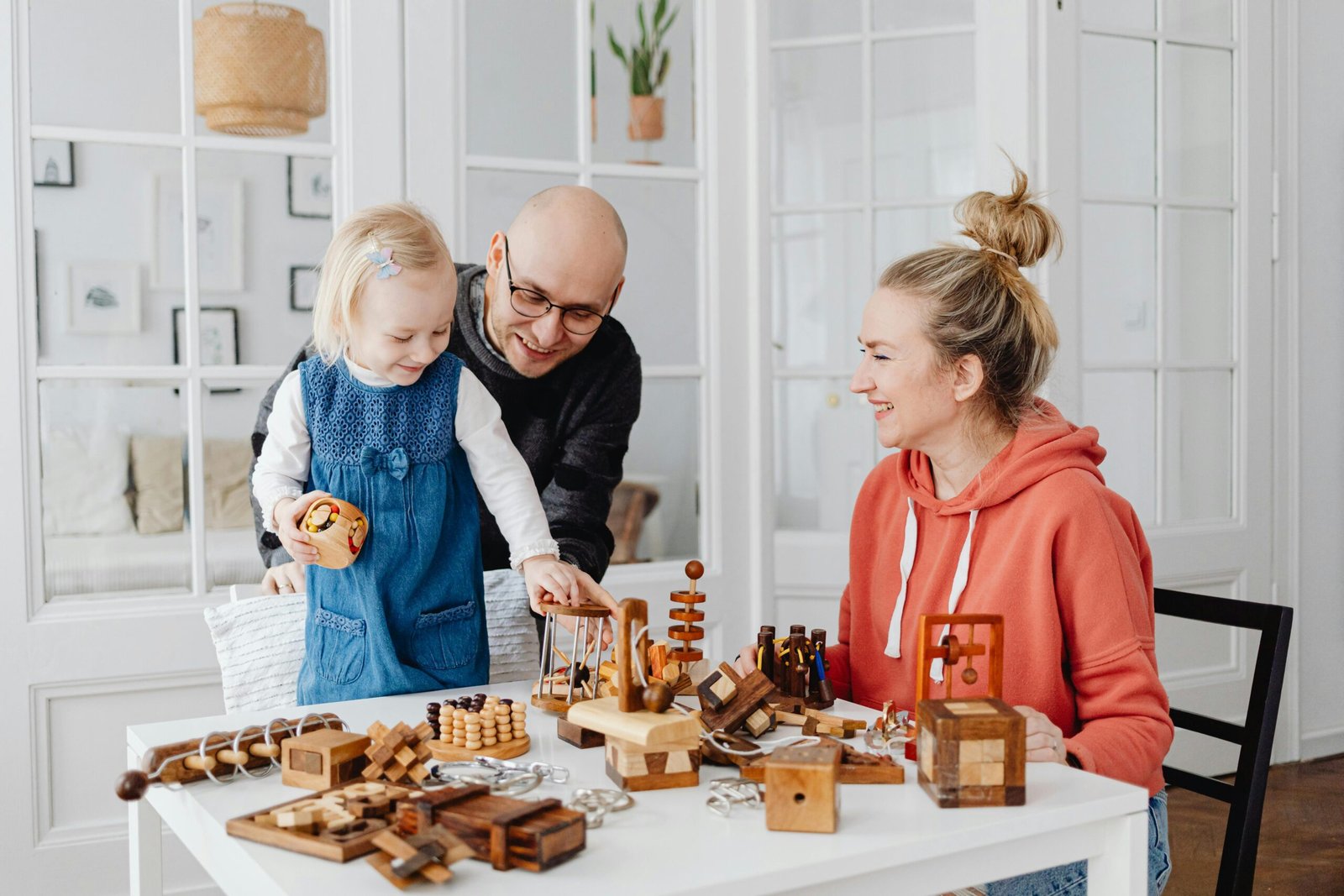 pexels-photo-7296662-7296662 A happy family playing with wooden toys indoors, fostering creativity and bonding.